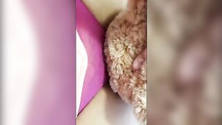 A girl is having fun with her teddy bear in a unique way
