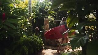 A couple enjoys passionate sex on a beach during their romantic getaway