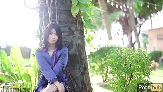 A cute Asian girl plays with her pussy in the garden