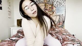 A small-breasted Chinese girl with glasses caresses her boobs and gets wet from the vibrator