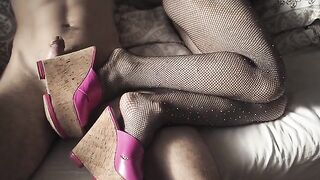 A girl in sexy high heels and stockings is touching herself