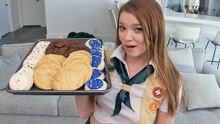 The girl is motivated to sell cookies and she would do anything for them