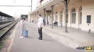 A cute girl is meeting a guy on the train station to earn some money