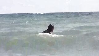 Two girls are getting sunbathing on the naked beach