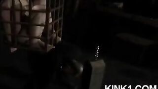 A slave in a cage fulfills all the orders of the master