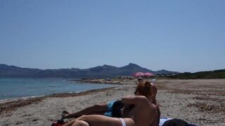 Public blowjob action on the beach with glasses on