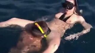 Underwater sex of two aqualangists at the bottom of the sea