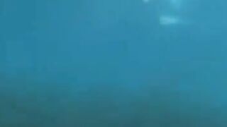 Underwater sex of two aqualangists at the bottom of the sea