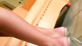 Beautiful woman masturbating on a leather chair and reaching a powerful orgasm