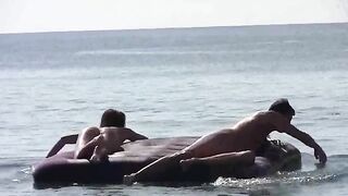 A blonde is getting naked on the sandy bank