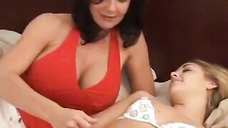 A young woman is having fun with her mature girlfriend using a strap-on