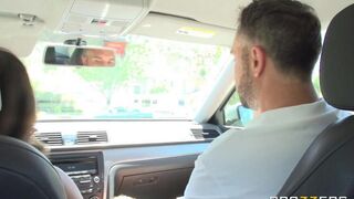 A girl is having fun with her driving instructor in the car