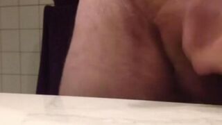 The man, in the power of sperm, lowers hot semen to the table