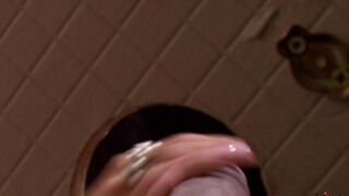 A woman pulled a cock through the hole in the toilet and started sucking it