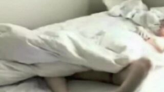 A girl was photographed masturbating in bed, unaware of the hidden camera
