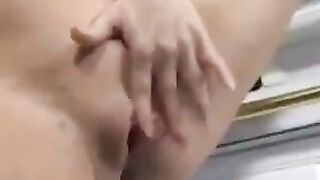 A pregnant woman has a messy cumshot in her kitchen while cooking