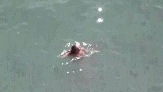 A pair of naked people at the bottom of the sea