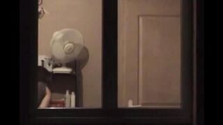 The guy admires himself in the mirror, standing in front of him completely naked