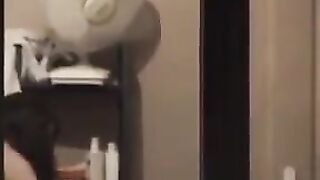 The guy admires himself in the mirror, standing in front of him completely naked
