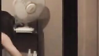 The guy admires himself in the mirror, standing in front of him completely naked