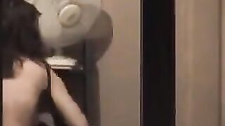 The guy admires himself in the mirror, standing in front of him completely naked