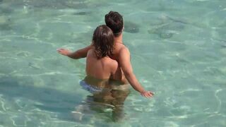 A girl was jerking off a guy at sea in the water