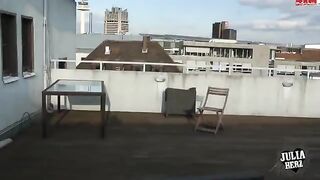 A hot brunette with big natural tits bounces on a cock on the roof terrace