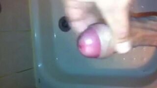 The kid masturbates his dick in the shower