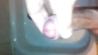 The kid masturbates his dick in the shower