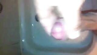 The kid masturbates his dick in the shower