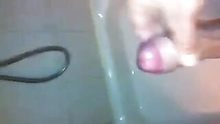 The kid masturbates his dick in the shower