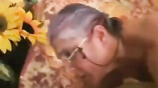 A man has sex with a gray-haired woman in black stockings