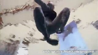 A hot naked girl is playing in the pool with a videographer