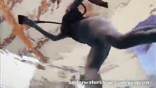 A hot naked girl is playing in the pool with a videographer