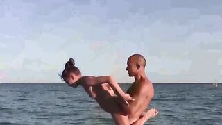 Nudist girl practices acrobatics on the naked beach