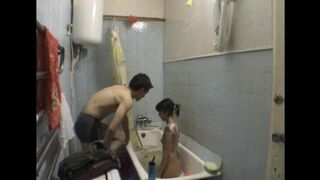 A girl is having fun with her brother in the bathroom