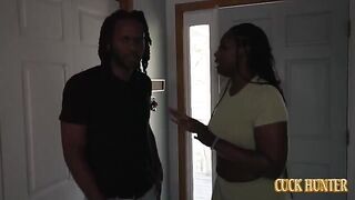 A girl is having fun with a black guy on the couch in front of her husband
