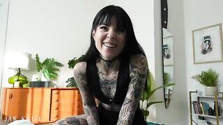 A girl with a vibrator advertises her stuff on the bed she shares with her friend