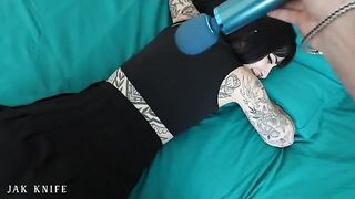 A girl with a vibrator advertises her stuff on the bed she shares with her friend