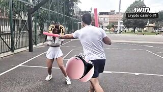 The girl is having fun with her coach in the gym, getting sweaty
