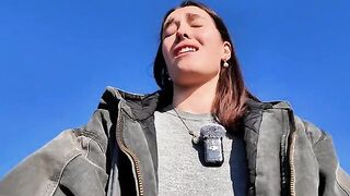 A hot brunette babe masturbates on a public beach, taking a big risk