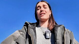 A hot brunette babe masturbates on a public beach, taking a big risk