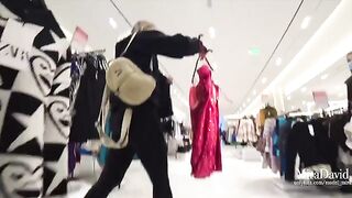 A hot chick is almost caught while giving a blowjob in the fitting room